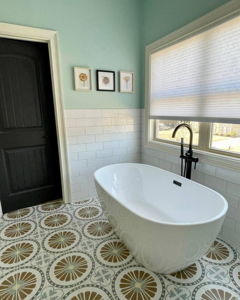 Bathroom remodel with green walls, wood vanity, black fixtures, and glass shower