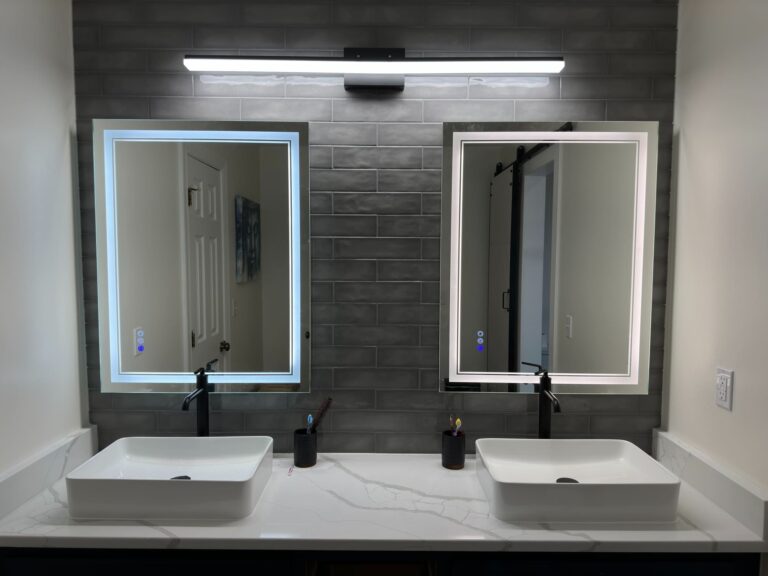 Modern bathroom with frameless glass shower, dual-sink vanity, and LED mirrors
