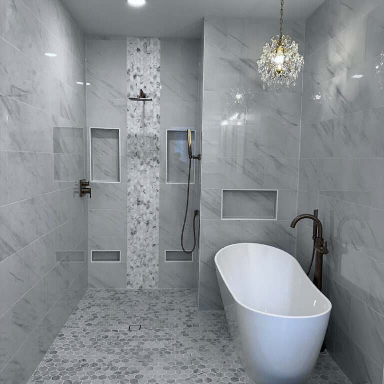 Elegant wet room bathroom with freestanding tub, walk-in shower, and marble-look tile