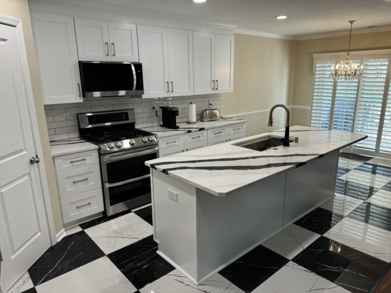 Kitchen with dramatic black-and-white finishes, central island, and updated cabinets
