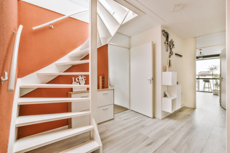 orange white living room with staircase