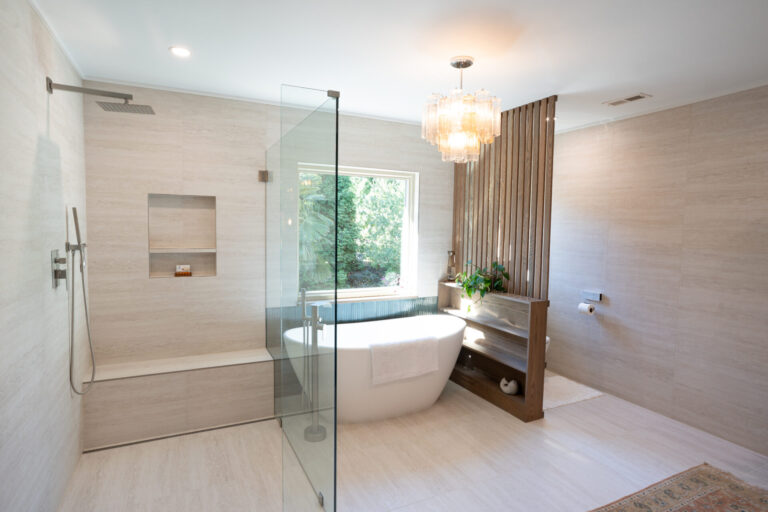 Spa-inspired bathroom with freestanding tub, glass shower, and custom wood partition