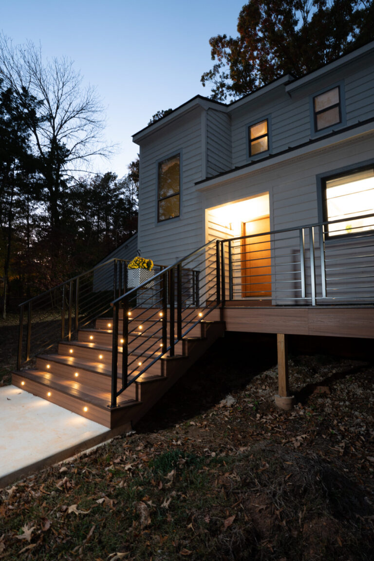 Modern entry deck with illuminated stairs and elevated outdoor platform