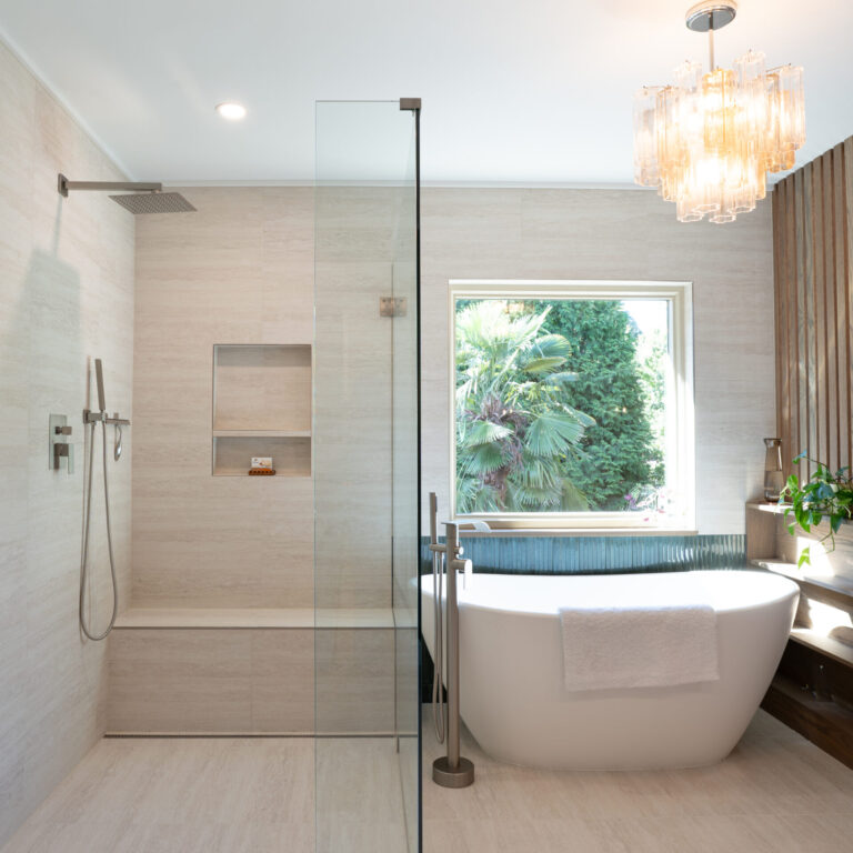 Spa-inspired bathroom remodel with freestanding tub, glass shower, and custom wood partition